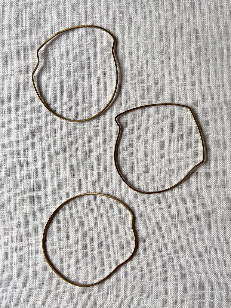 Organically shaped curvy brass bangles